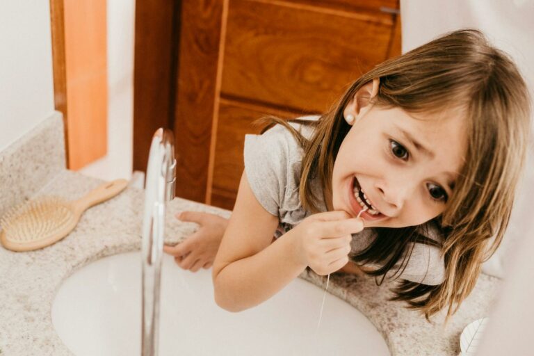 A Girl Flossing her Teeth